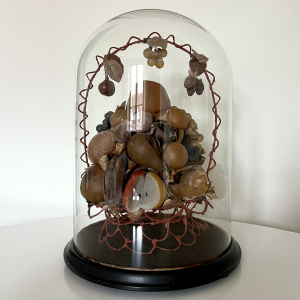 A large Victorian waxed fruit display in an impressive glass dome   