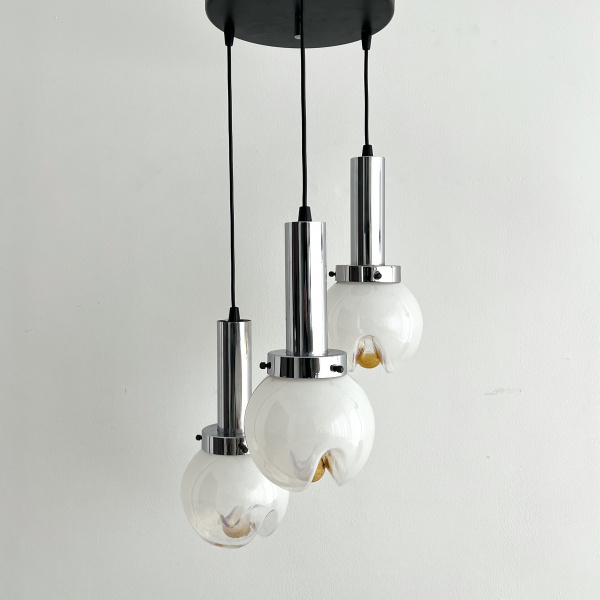 A Mezzega chandelier in a cascading trio of opaline to amber glass from the 1970s image
